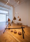 Color image of white walled gallery exhibiting sculptural sound artworks