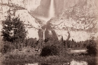 Albumen photograph of a waterfall flowing down a vertical rock outcrop reflected in a river in the foreground