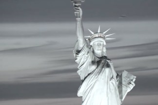 Color image of a screenshot of a video work depicting the statue of liberty