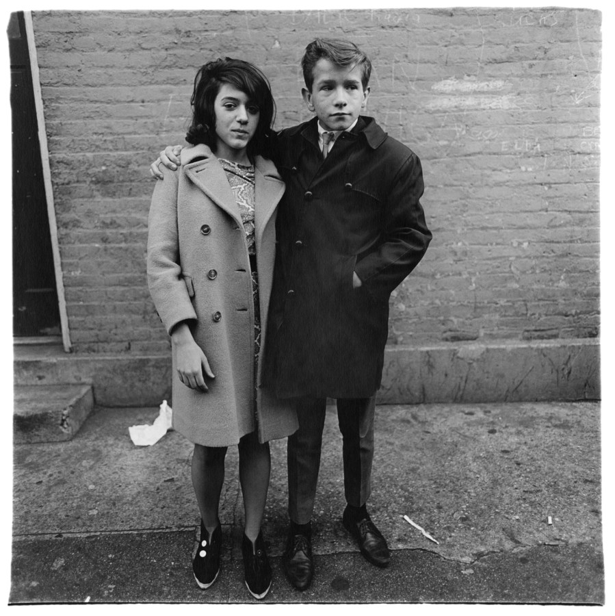 Black-and-white photograph of a young man with his arm around a young woman