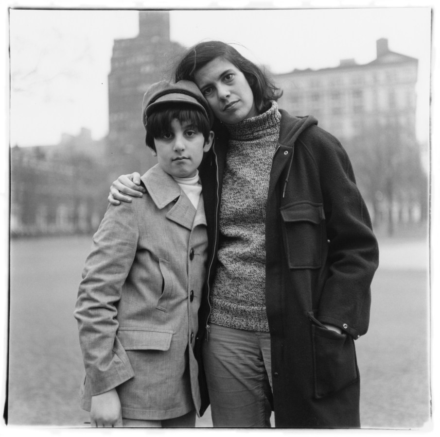 Black-and-white photograph of a woman with her arm around a boy