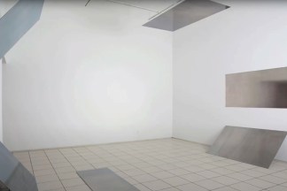 Color photograph of an installation depicting six silver toned photograms in white gallery space