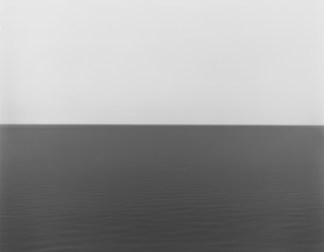 Black and white photograph of the horizon with equal parts sky and sea
