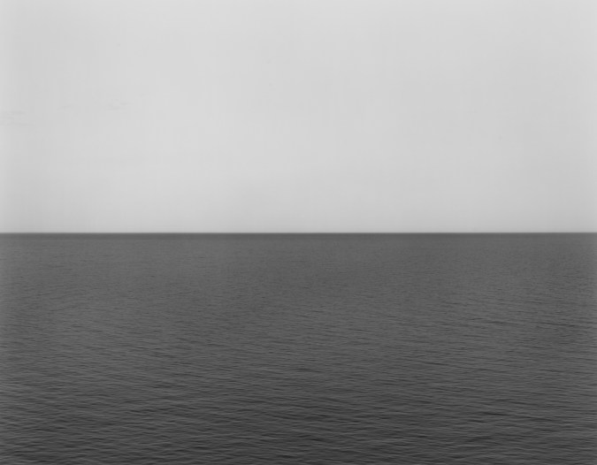 Black and white photograph of the horizon with equal parts sky and sea